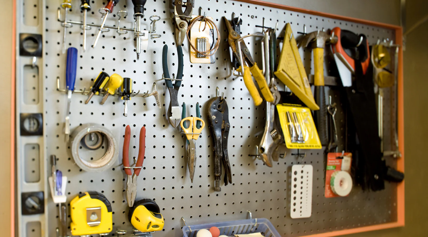 Organized hardware tools on pegboard wall showing efficient workshop organization